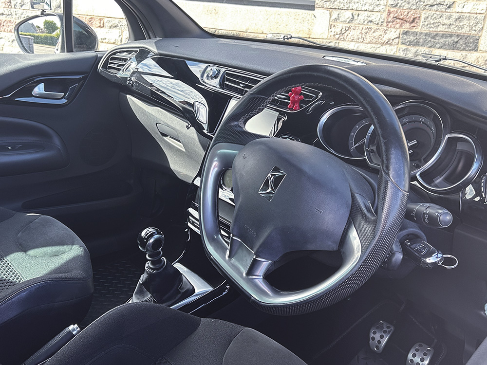 driver's seat showing steering wheel and gear stick